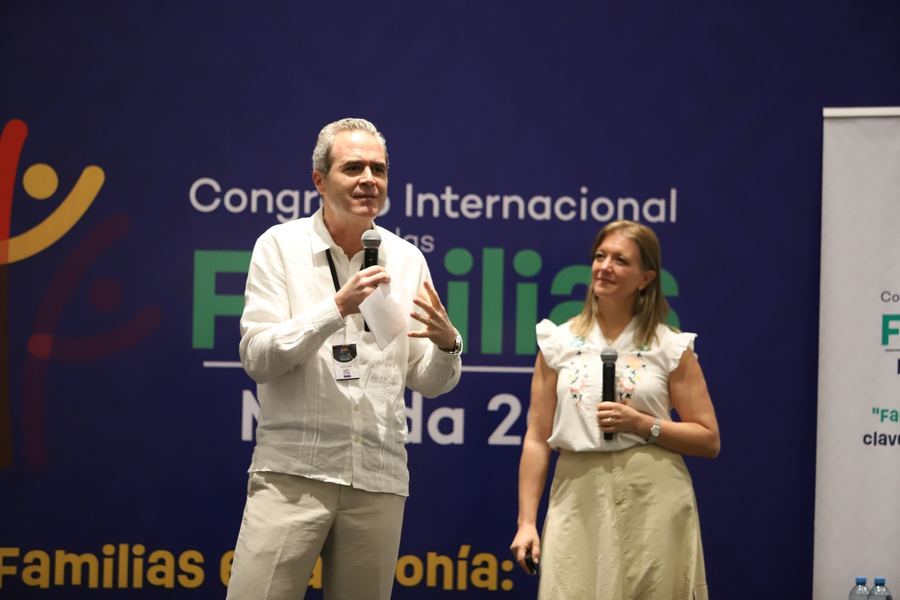 Dany y otro ponente frente al letrero del Congreso Internacional de las Familias, Mérida 2025.